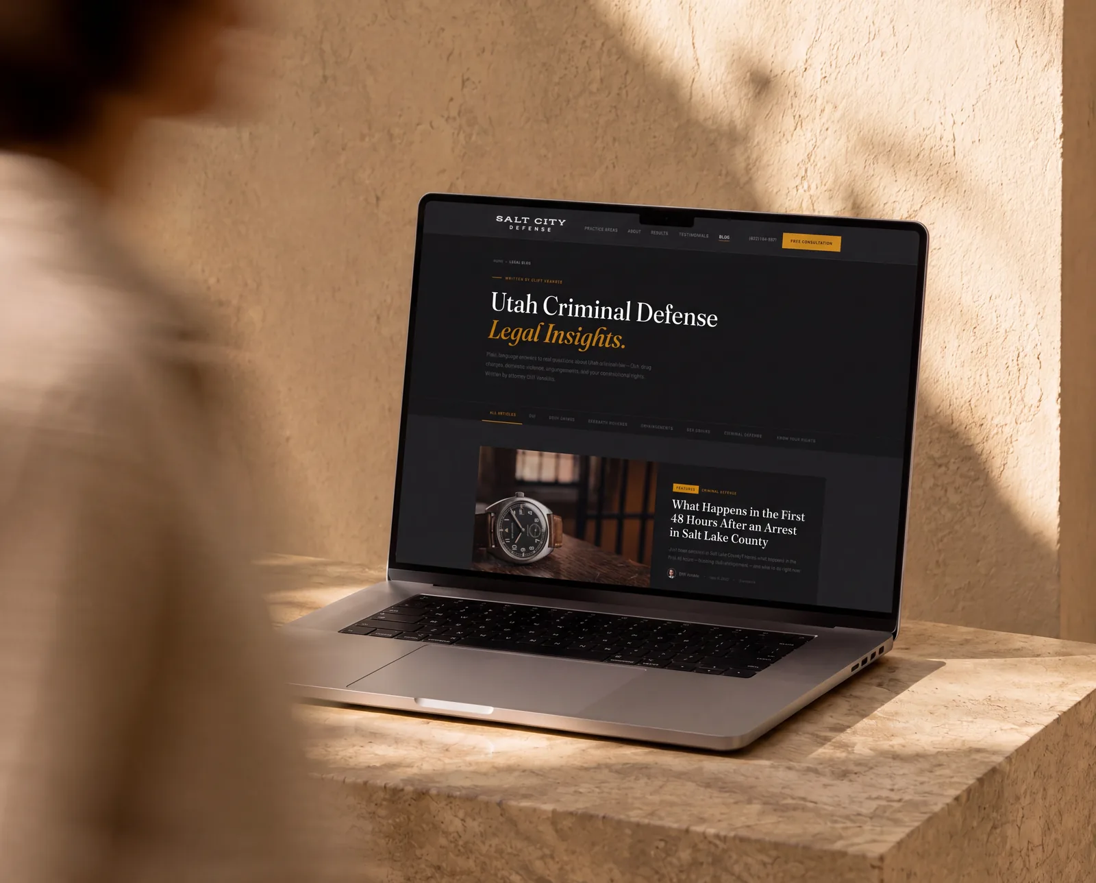 Rebuilt Salt City Defense blog page on a MacBook Pro